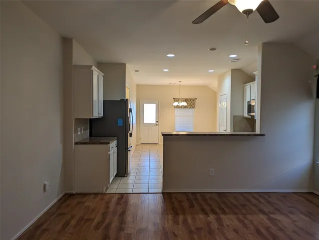 a view of kitchen with cabinets and wooden floor