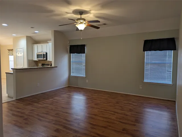 wooden floor in an empty room with a window