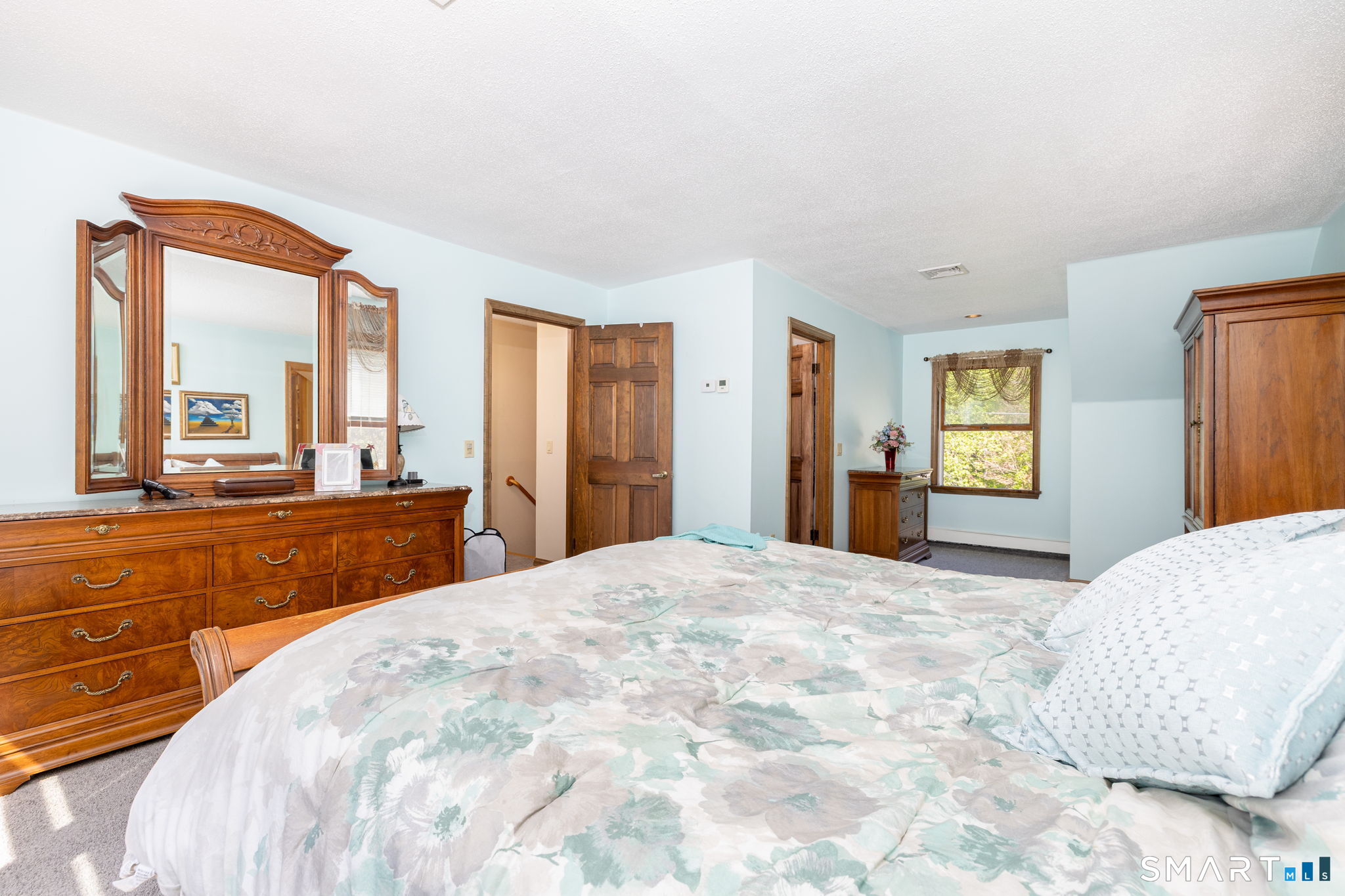 39 Chapman Road Marlborough, CT 06447 - Photo 19 of 40 a spacious bedroom with a large bed and a dresser