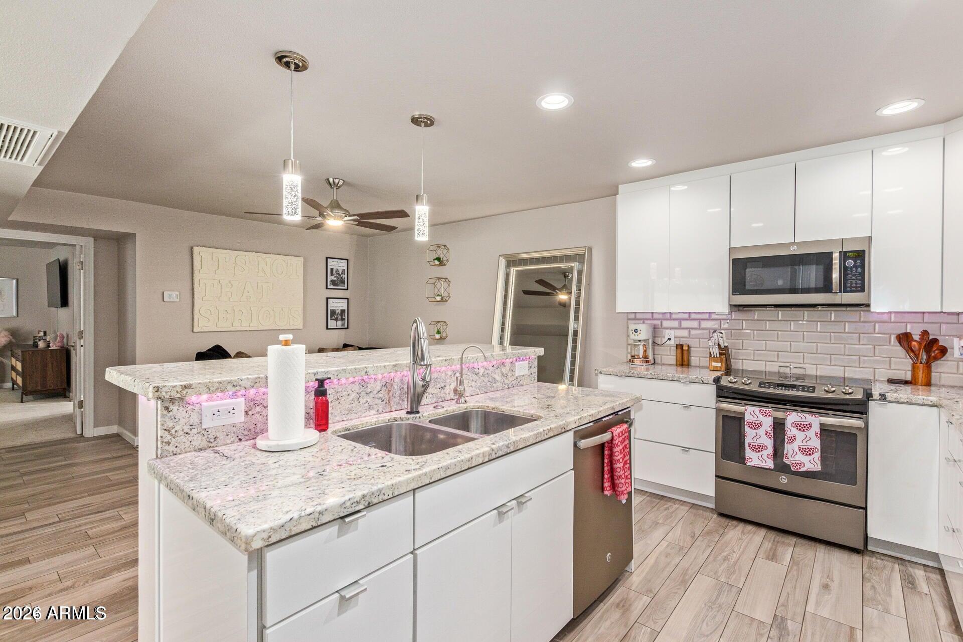 5913 East Thomas Road Scottsdale, AZ 85251 - Photo 5 of 26 a kitchen with a sink stove and cabinets