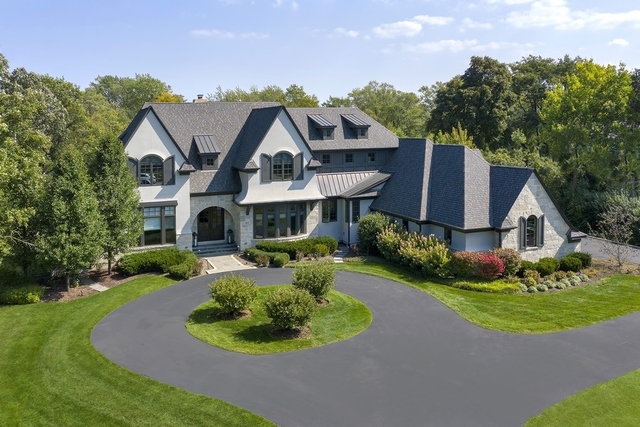a front view of a house with a yard fire pit and outdoor seating