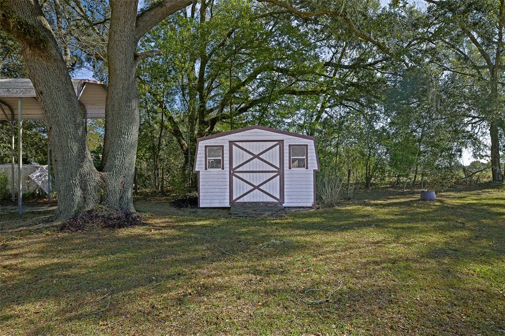 7452 Southeast 135th Street Summerfield, FL 34491 - Photo 18 of 43 a backyard of a house with lots of green space