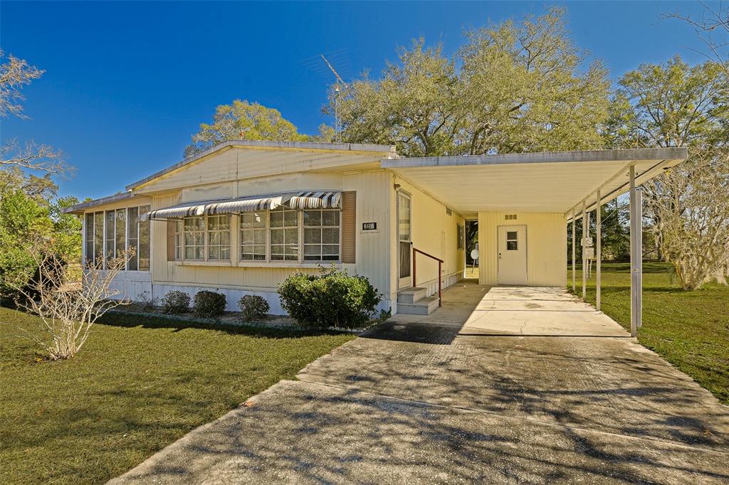 7452 Southeast 135th Street Summerfield, FL 34491 - Photo 20 of 43 a front view of a house with a yard
