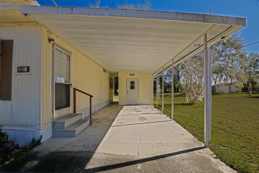 7452 Southeast 135th Street Summerfield, FL 34491 - Photo 21 of 43 a front view of a house with a garden