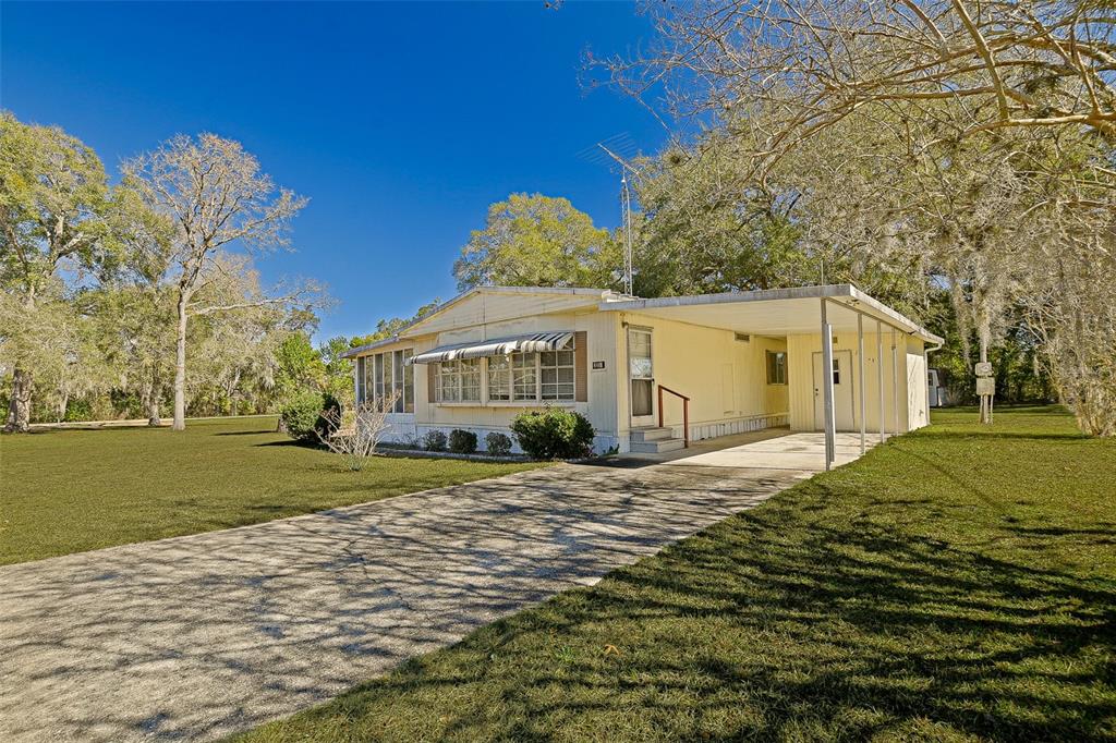 7452 Southeast 135th Street Summerfield, FL 34491 - Photo 22 of 43 a front view of a house with a yard