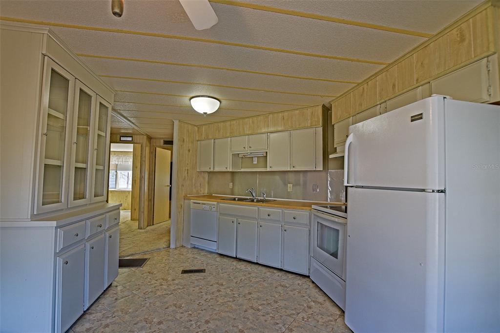 7452 Southeast 135th Street Summerfield, FL 34491 - Photo 25 of 43 a kitchen with a refrigerator and a sink