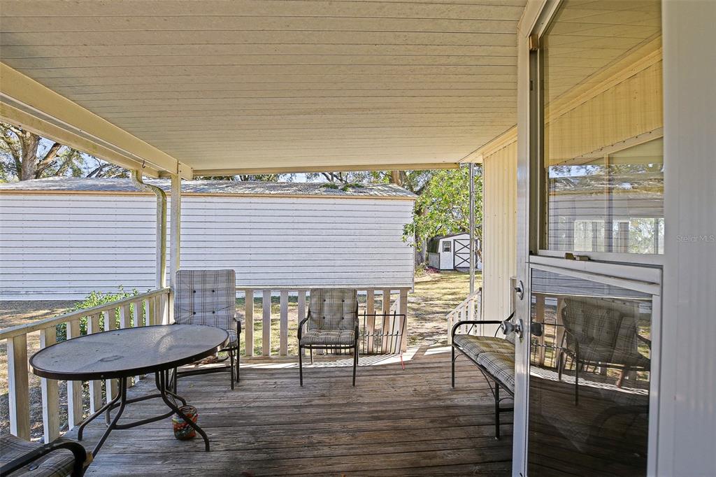 7452 Southeast 135th Street Summerfield, FL 34491 - Photo 33 of 43 a balcony with table and chairs