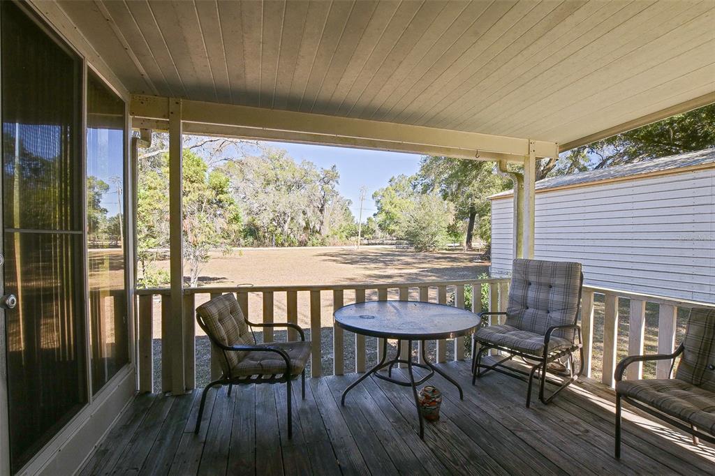 7452 Southeast 135th Street Summerfield, FL 34491 - Photo 34 of 43 a view of a dining room with furniture window and wooden floor