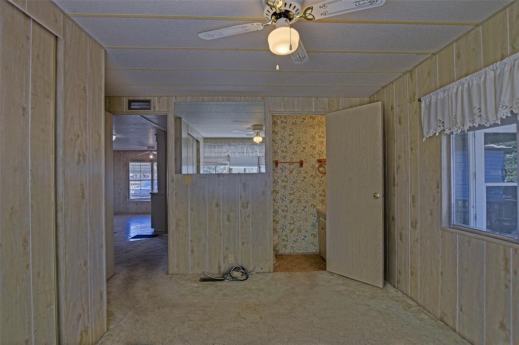 7452 Southeast 135th Street Summerfield, FL 34491 - Photo 41 of 43 a view of a hallway with a bathroom
