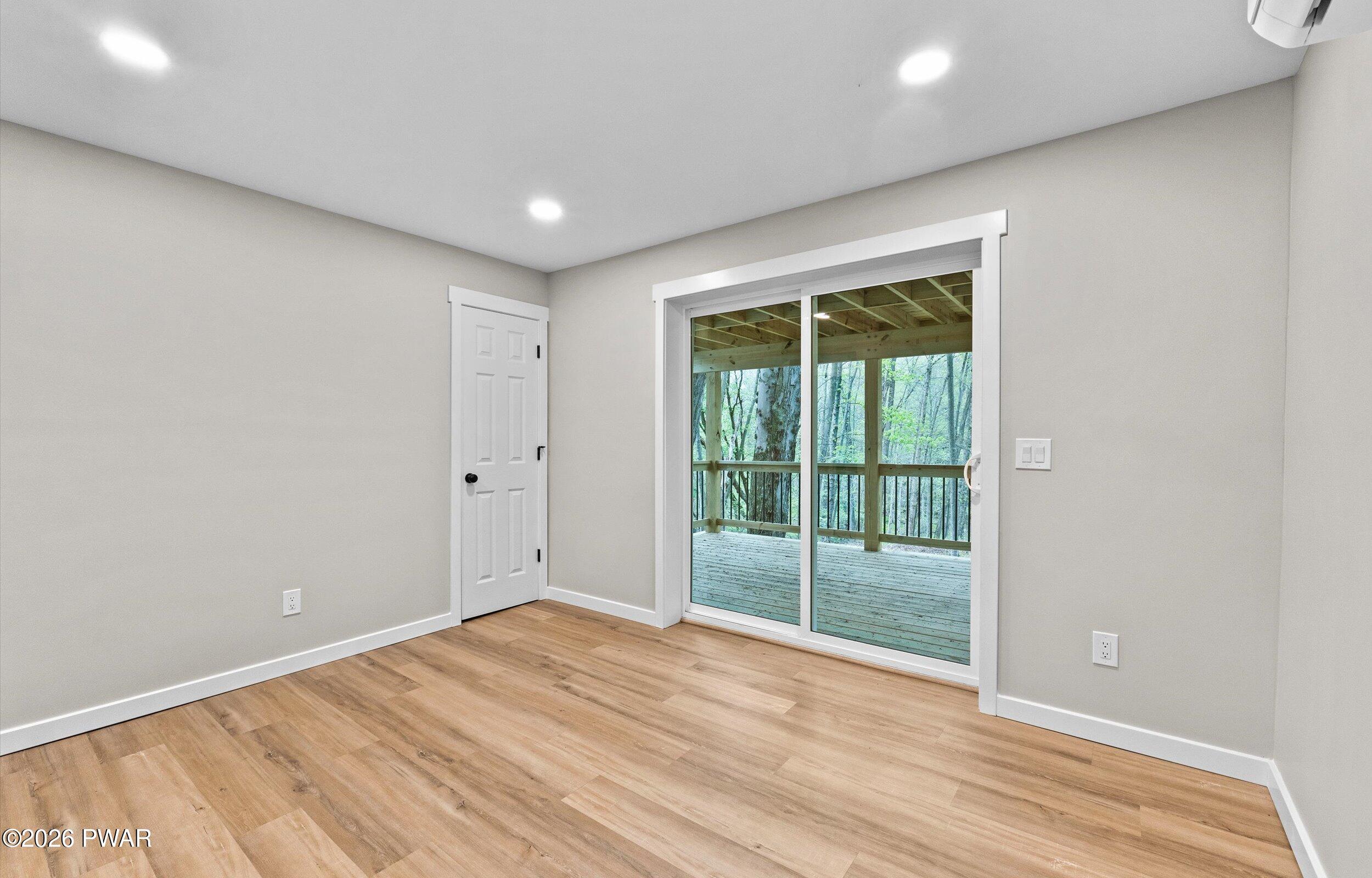 9 High Point Court Lake Ariel, PA 18436 - Photo 27 of 40 a view of an empty room with wooden floor and a window