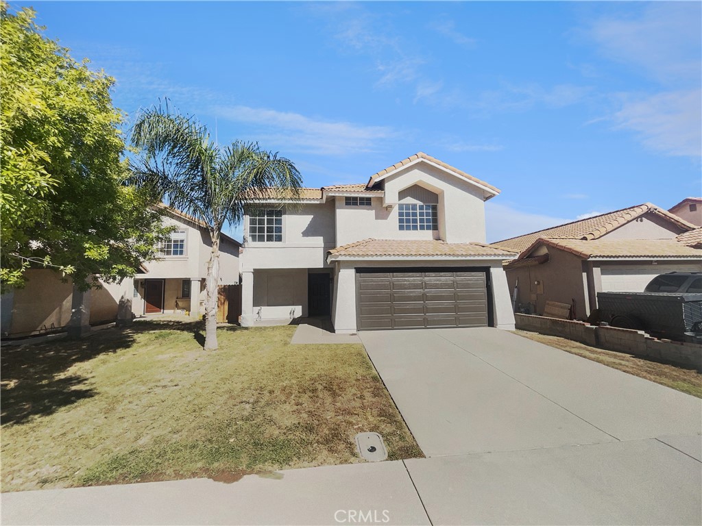 662 Spinnaker Drive Perris, CA 92571 - Photo 1 of 23 a front view of a house with a yard and garage