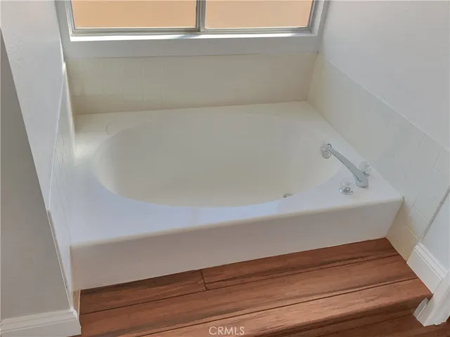 a spacious bathroom with a granite countertop double vanity sink and a mirror