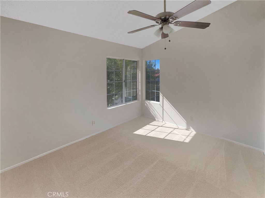 662 Spinnaker Drive Perris, CA 92571 - Photo 3 of 23 en empty room with windows and fan