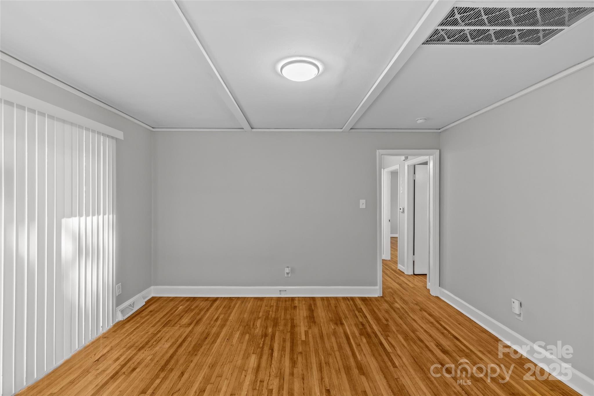 8341 Reedy Creek Road Charlotte, NC 28215 - Photo 16 of 40 an empty room with wooden floor and windows