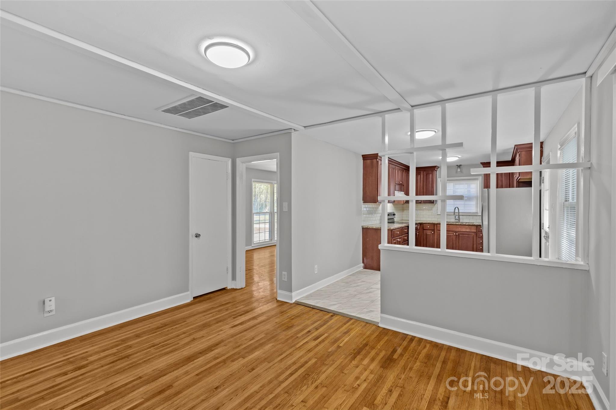 8341 Reedy Creek Road Charlotte, NC 28215 - Photo 17 of 40 a view of a big room with wooden floor and windows