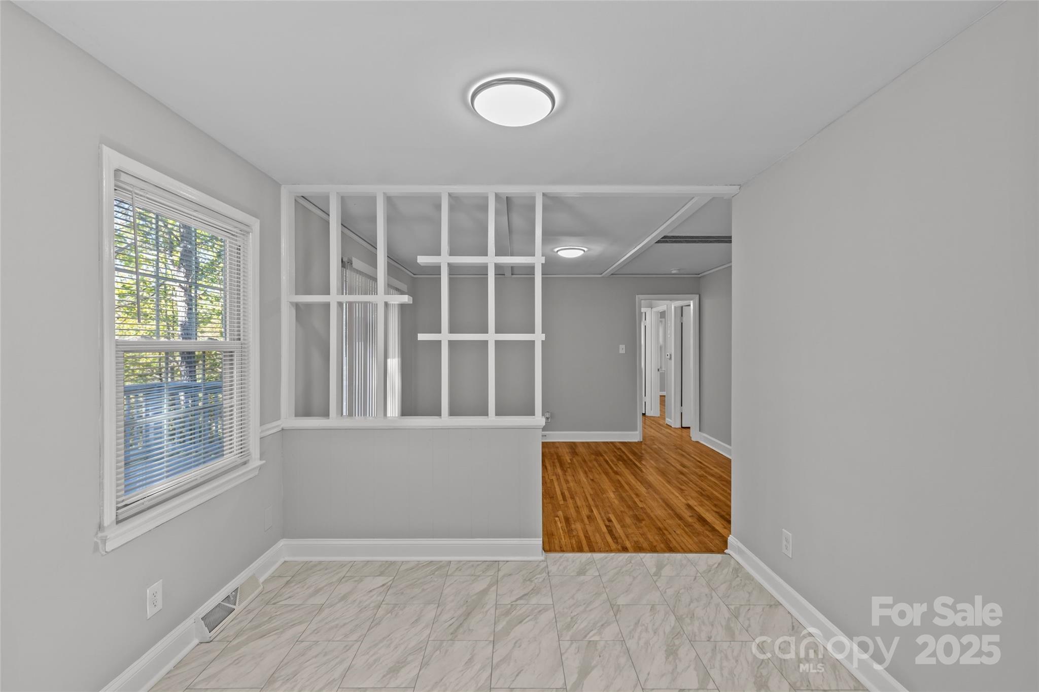 8341 Reedy Creek Road Charlotte, NC 28215 - Photo 20 of 40 a view of wooden floor and windows in a room