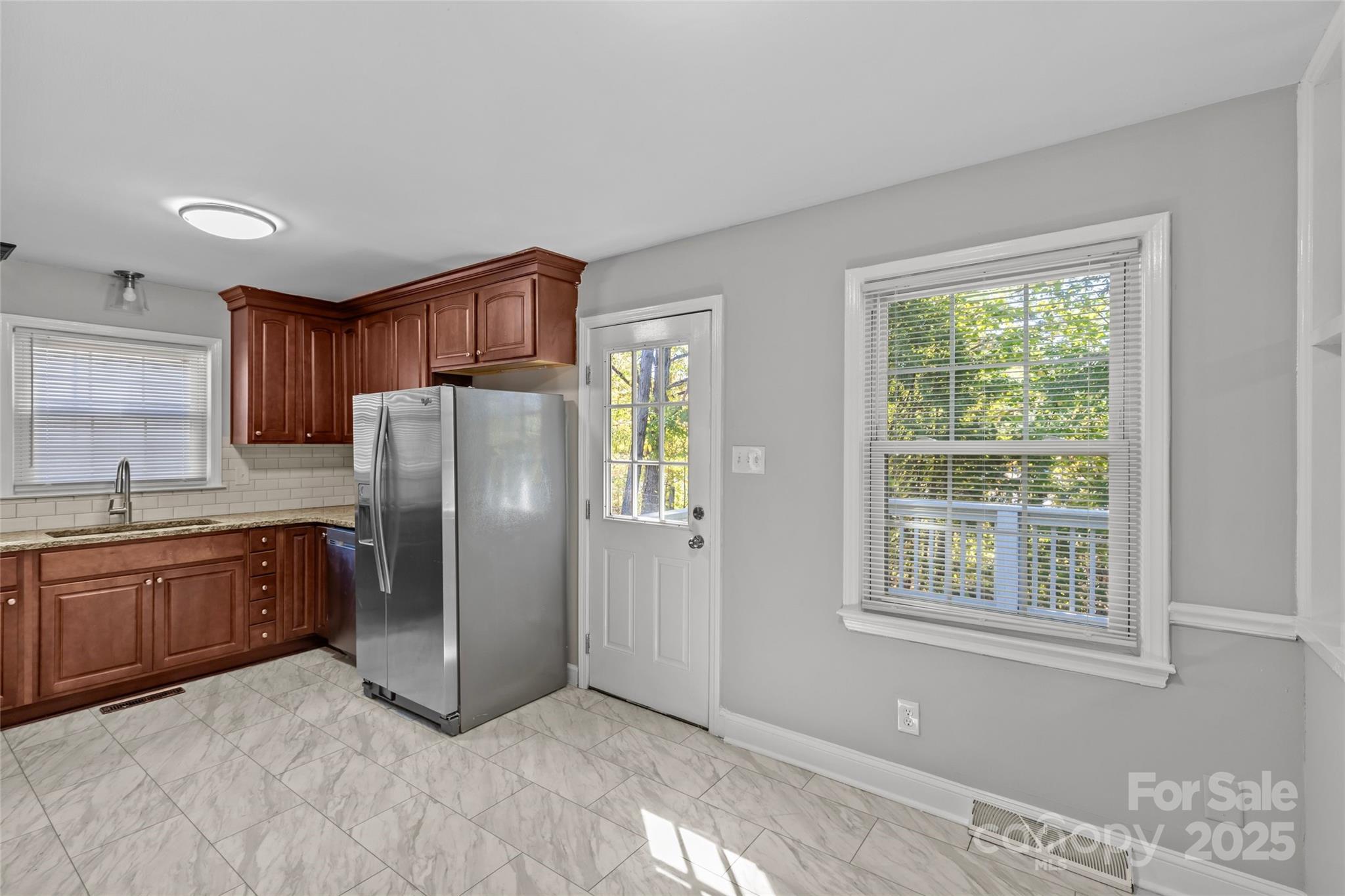 8341 Reedy Creek Road Charlotte, NC 28215 - Photo 22 of 40 a kitchen with stainless steel appliances granite countertop a refrigerator and a sink