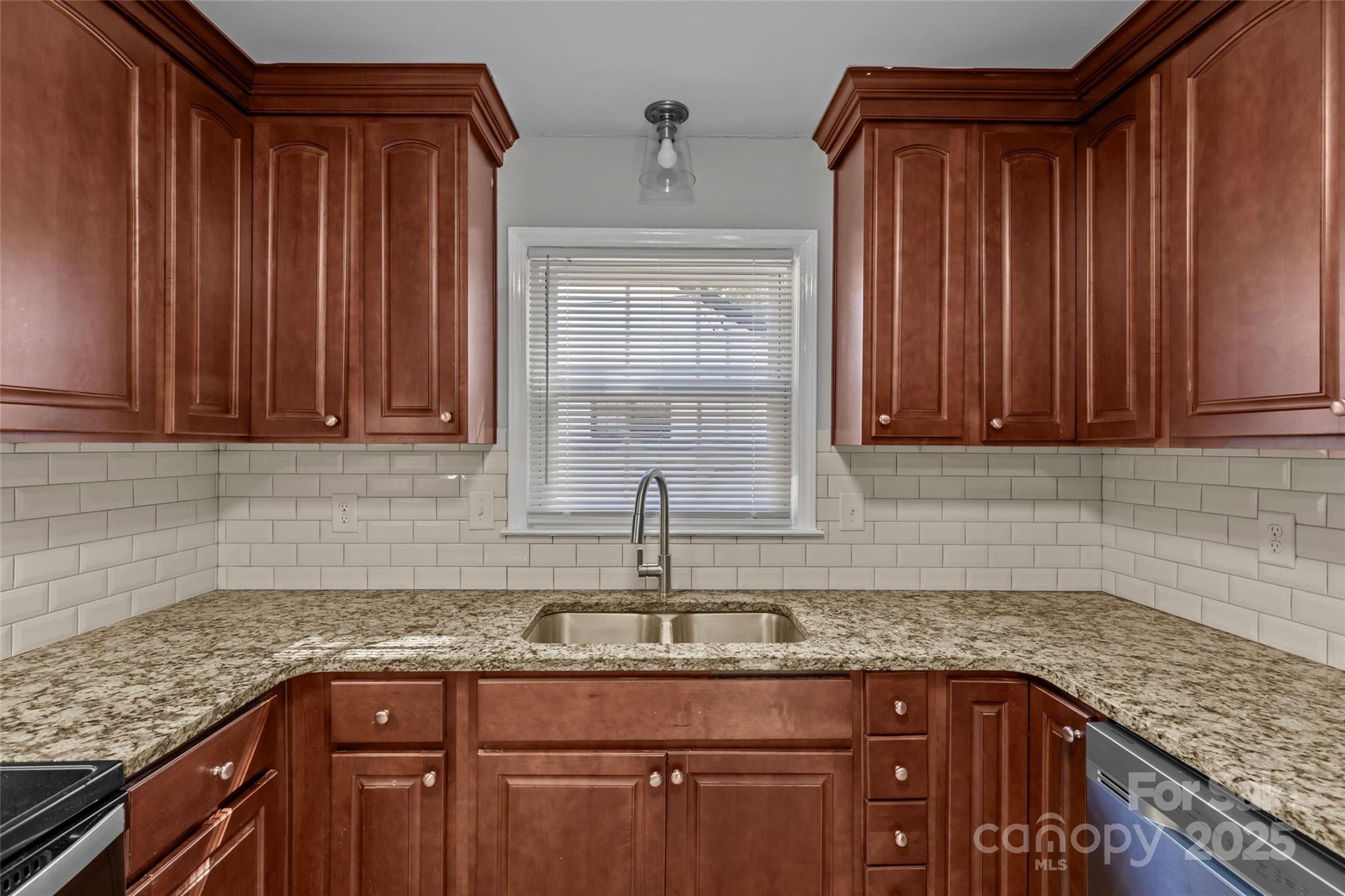 8341 Reedy Creek Road Charlotte, NC 28215 - Photo 23 of 40 a kitchen with granite countertop cabinets sink and window