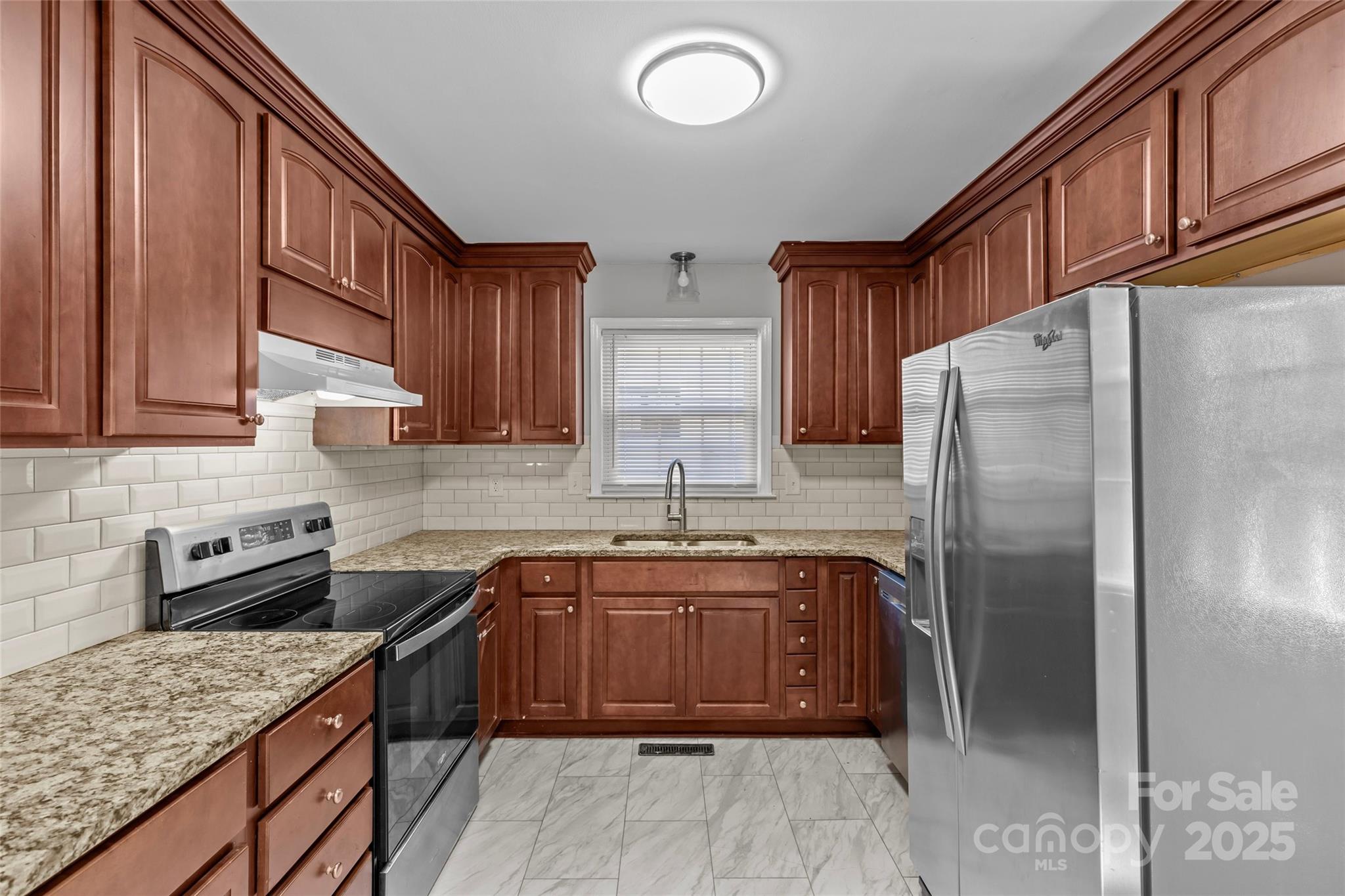 8341 Reedy Creek Road Charlotte, NC 28215 - Photo 25 of 40 a kitchen with stainless steel appliances granite countertop a sink stove and refrigerator