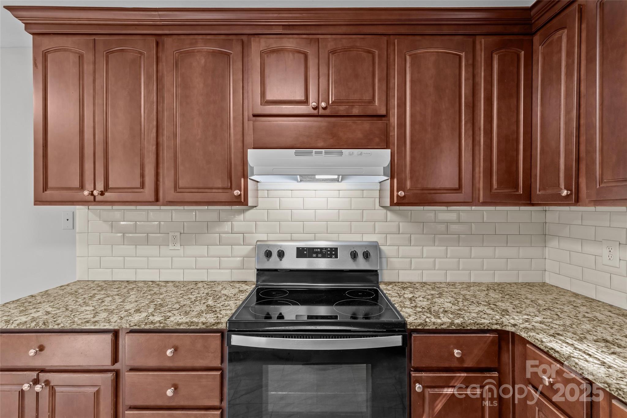 8341 Reedy Creek Road Charlotte, NC 28215 - Photo 26 of 40 a kitchen with granite countertop a stove sink and cabinets