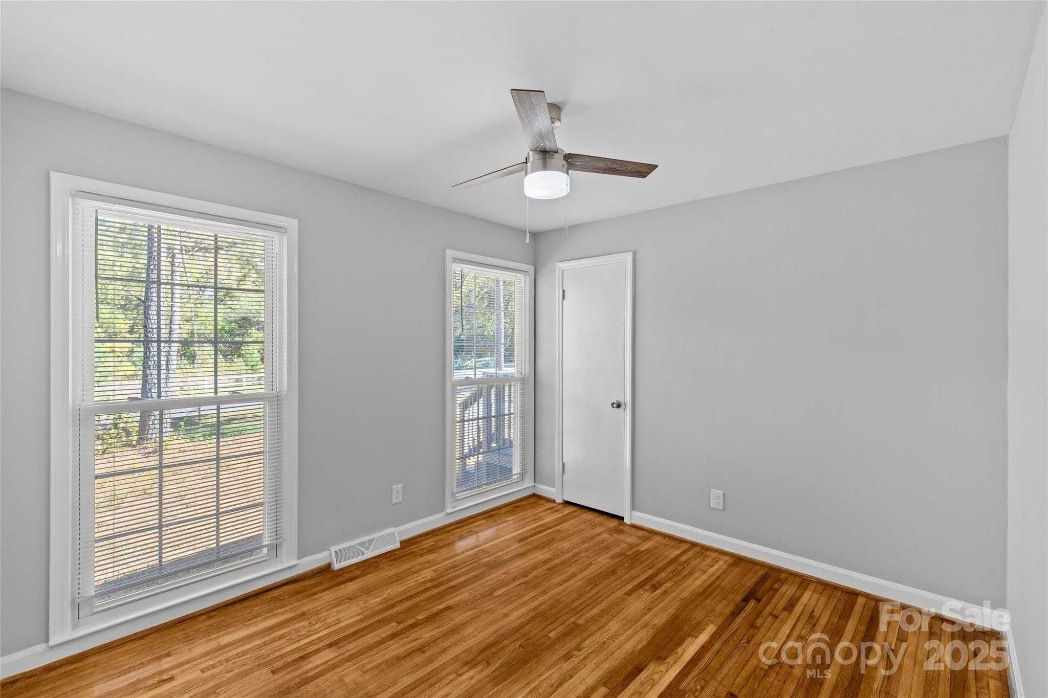 8341 Reedy Creek Road Charlotte, NC 28215 - Photo 29 of 40 wooden floor in an empty room with a window