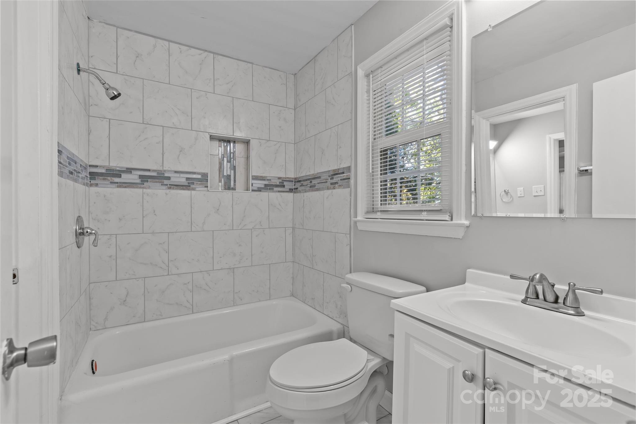 8341 Reedy Creek Road Charlotte, NC 28215 - Photo 30 of 40 a bathroom with a sink a toilet and shower