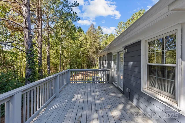 a view of a balcony with wooden floor and fence