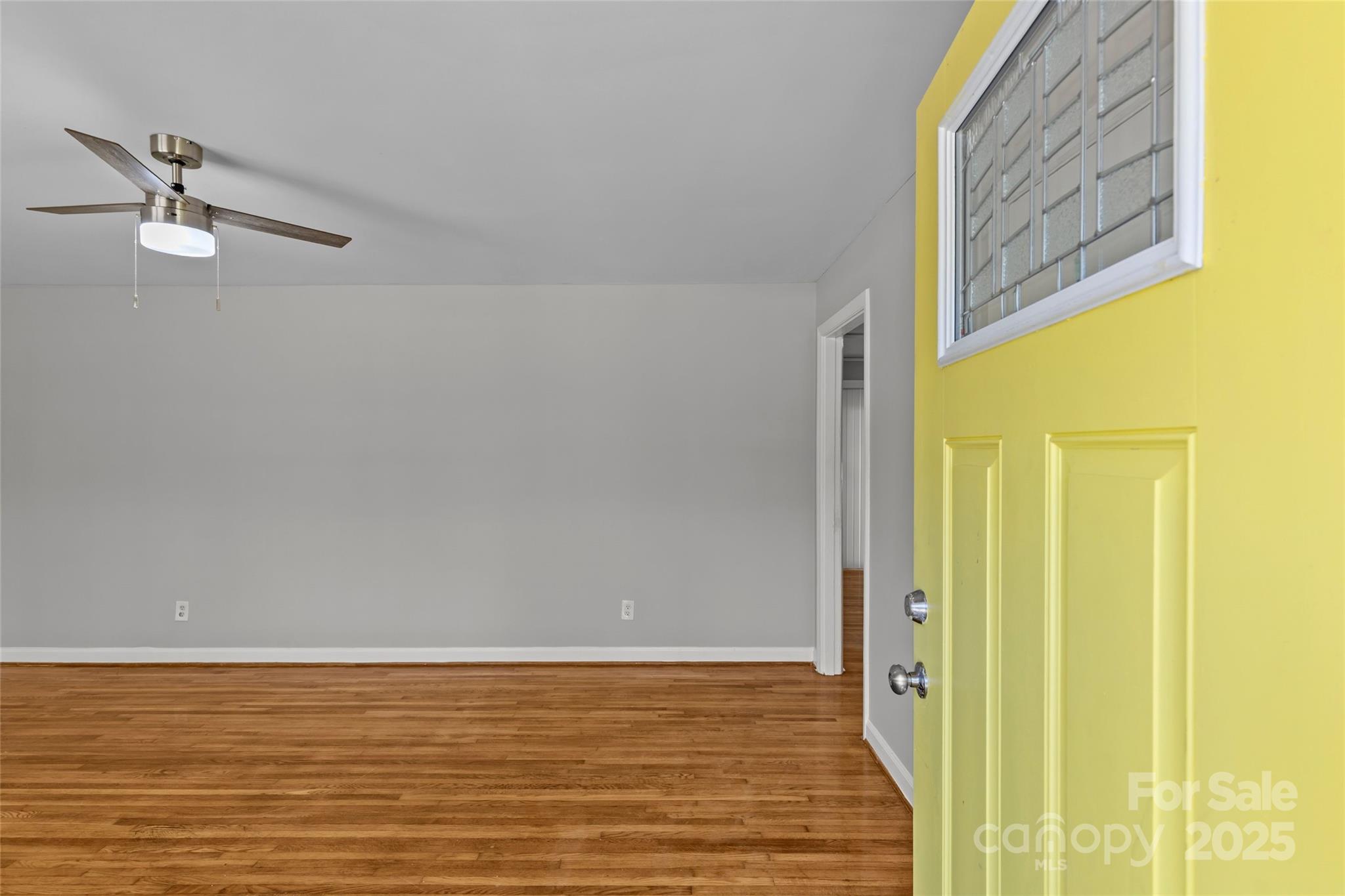 8341 Reedy Creek Road Charlotte, NC 28215 - Photo 6 of 40 a view of a room with wooden floor and windows