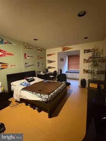 a bed sitting in a bedroom next to a window