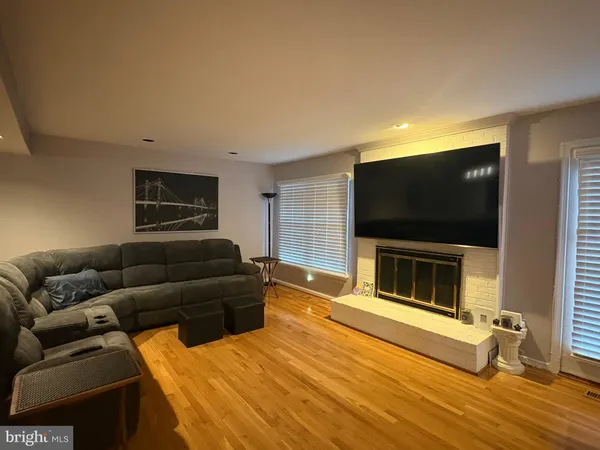 a living room with a flat screen tv and a fireplace