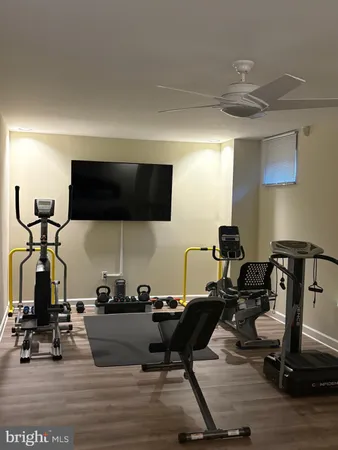 a room with gym equipment and a flat screen tv