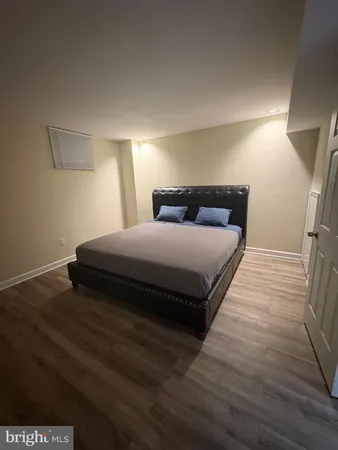 a bedroom with a bed and a night stand