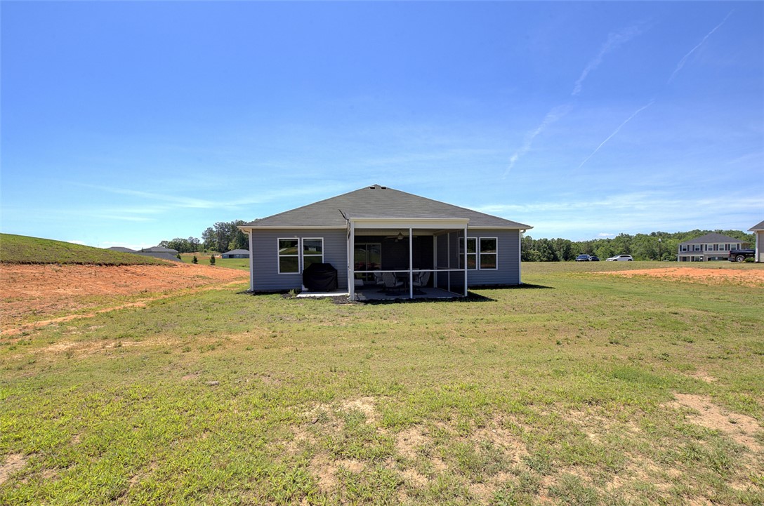 408 Chadwick Lane Walhalla, SC 29691 - Photo 31 of 44 A spacious backyard with an inviting screened porch perfect for outdoor living.