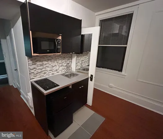 a kitchen with a sink and a microwave
