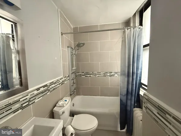 a bathroom with a toilet and a bathtub