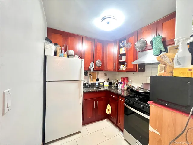 a kitchen with refrigerator and cabinets