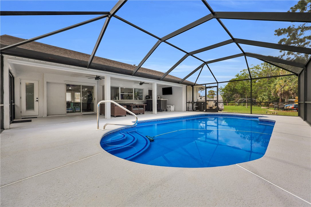 1950 Southwest Logwood Road Port St. Lucie, FL 34953 - Photo 27 of 32 a view of a swimming pool with a patio