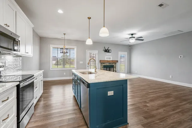 a kitchen with granite countertop a stove and a sink