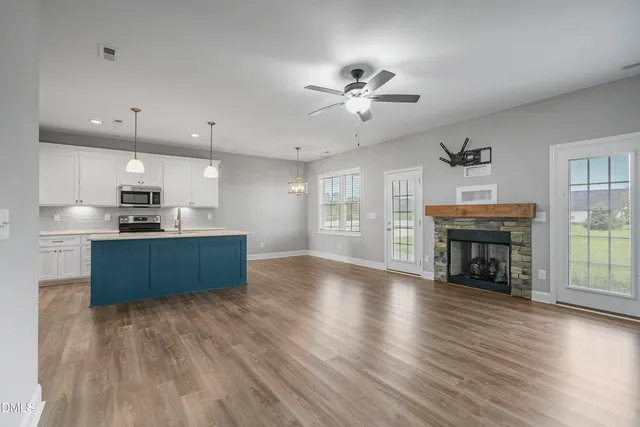 a kitchen with stainless steel appliances kitchen island wooden cabinets and granite counter tops