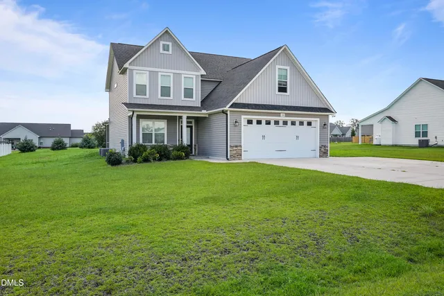 a front view of a house with a yard and garage