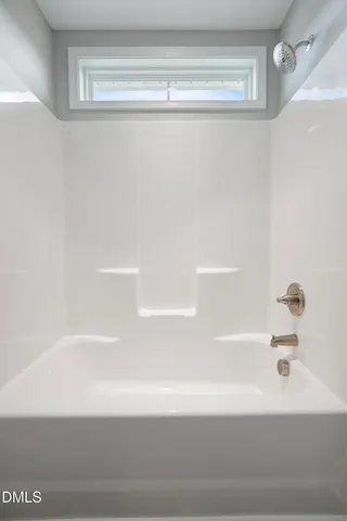 a bathroom with a granite countertop sink a mirror and a shower