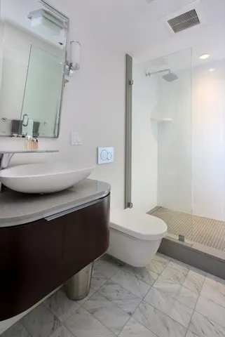 a bathroom with a sink toilet and shower