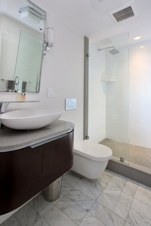 220 Boylston Street, Unit 1612/1624 Boston, MA 02116 - Photo 15 of 26 a bathroom with a sink toilet and shower