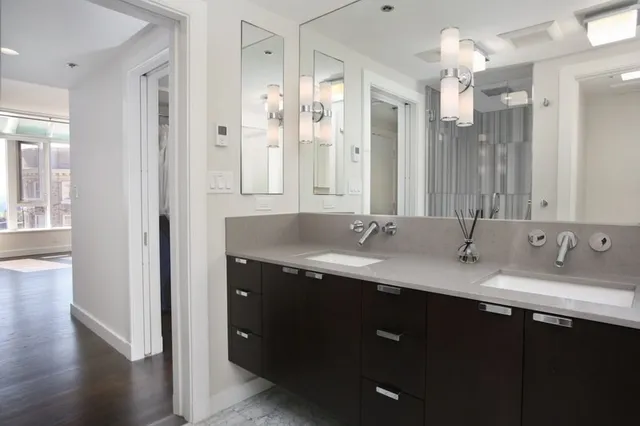 a bathroom with a granite countertop sink double vanity granite and a mirror