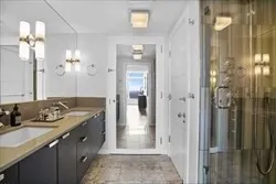 a bathroom with a granite countertop sink a shower and a mirror