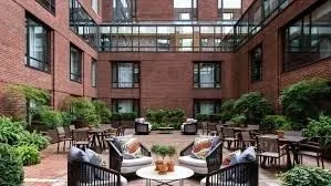 a view of a patio with couches table and chairs and potted plants