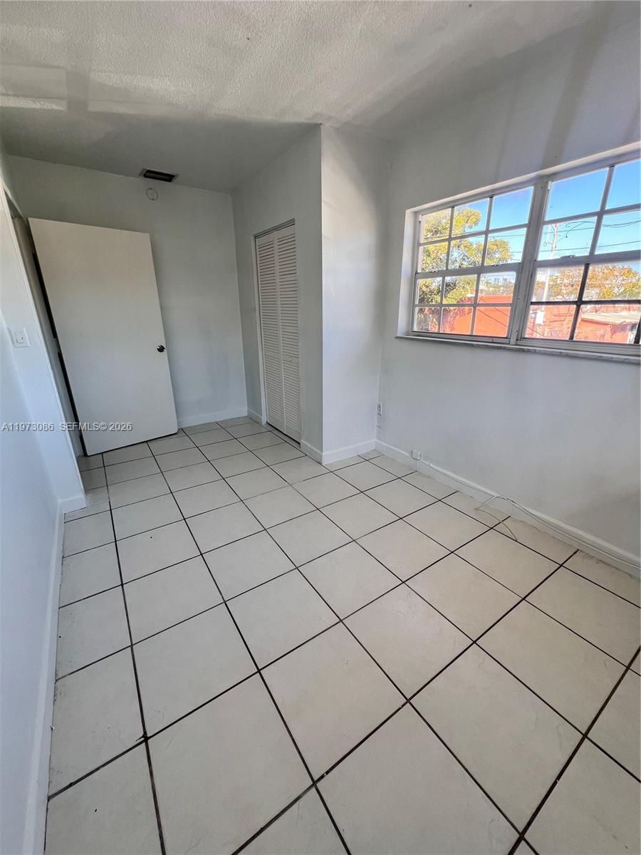 608 Southwest 15th Avenue, Unit 2 Miami, FL 33135 - Photo 12 of 22 a view of an empty room and window