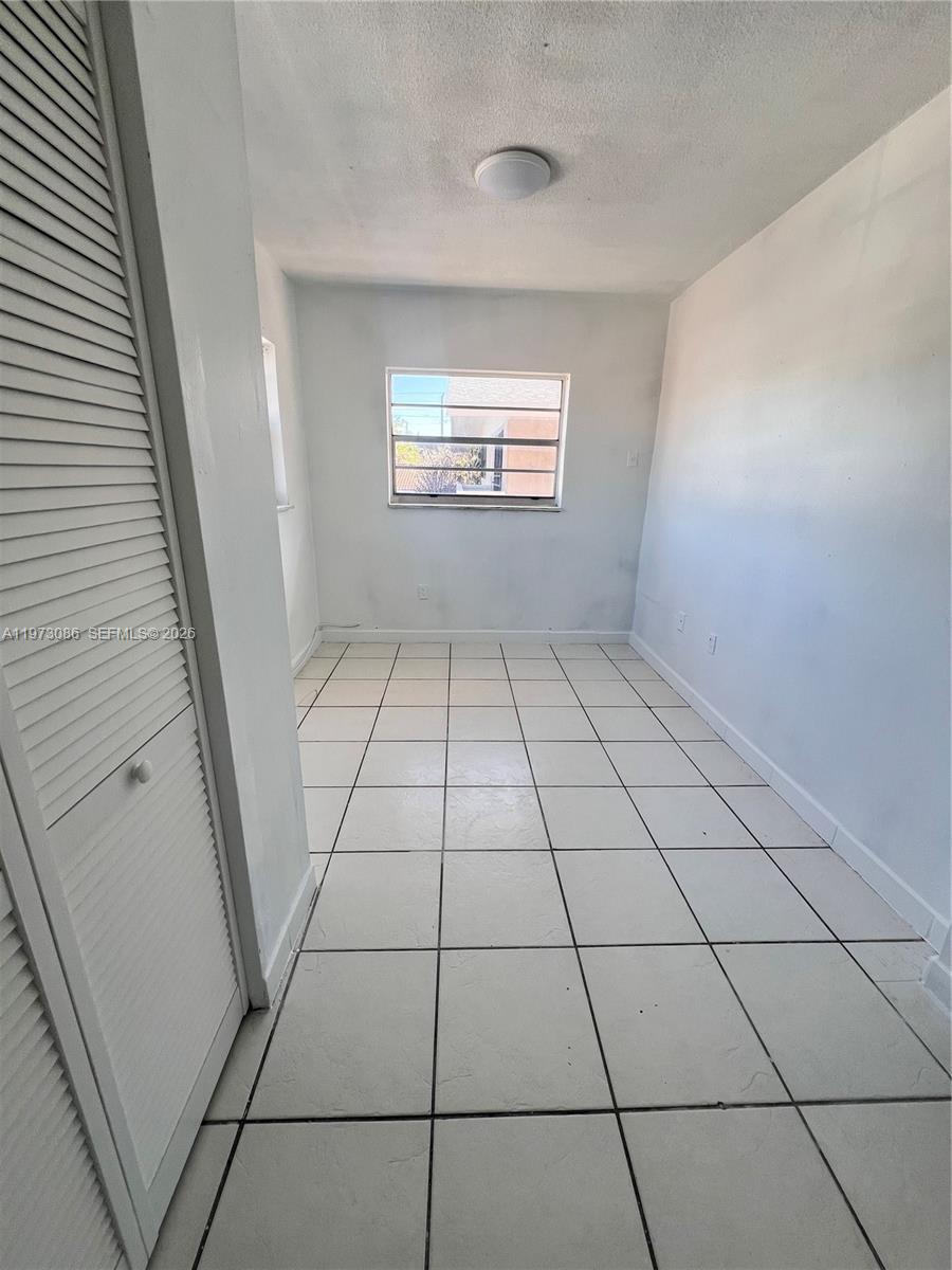 608 Southwest 15th Avenue, Unit 2 Miami, FL 33135 - Photo 14 of 22 a view of empty room with windows