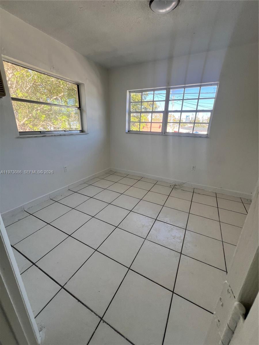 608 Southwest 15th Avenue, Unit 2 Miami, FL 33135 - Photo 15 of 22 a view of an empty room and window