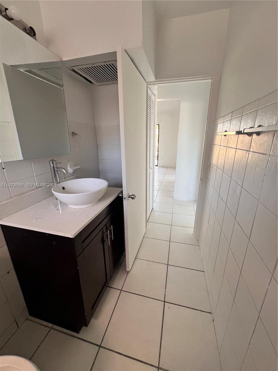 608 Southwest 15th Avenue, Unit 2 Miami, FL 33135 - Photo 21 of 22 a bathroom with a sink vanity and a mirror